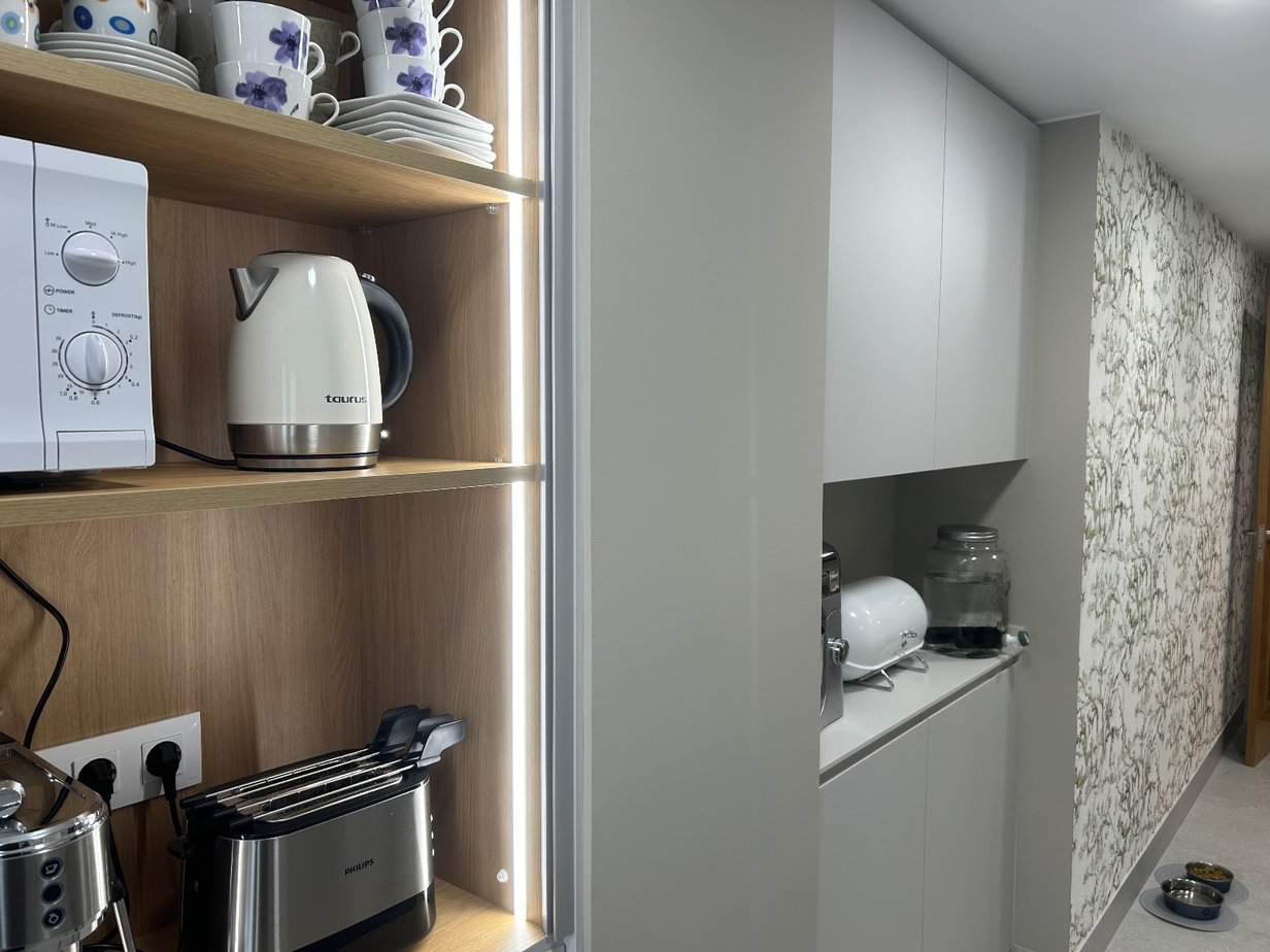 - Estantería con electrodomésticos y vajilla en cocina moderna de reformas e interiorismo Eiroa.